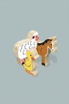 Wooden farm animal toy set featuring a sheep, duck, and horse with printed faces, shown on a blue  background with dimension callouts indicating 85mm height and 15mm thickness.
