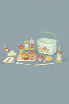 Set of wooden toys including a stacker, basket, and various other items on a light beige background