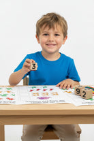 Wooden number blocks  with ink pads, and activity book  on a educational paper