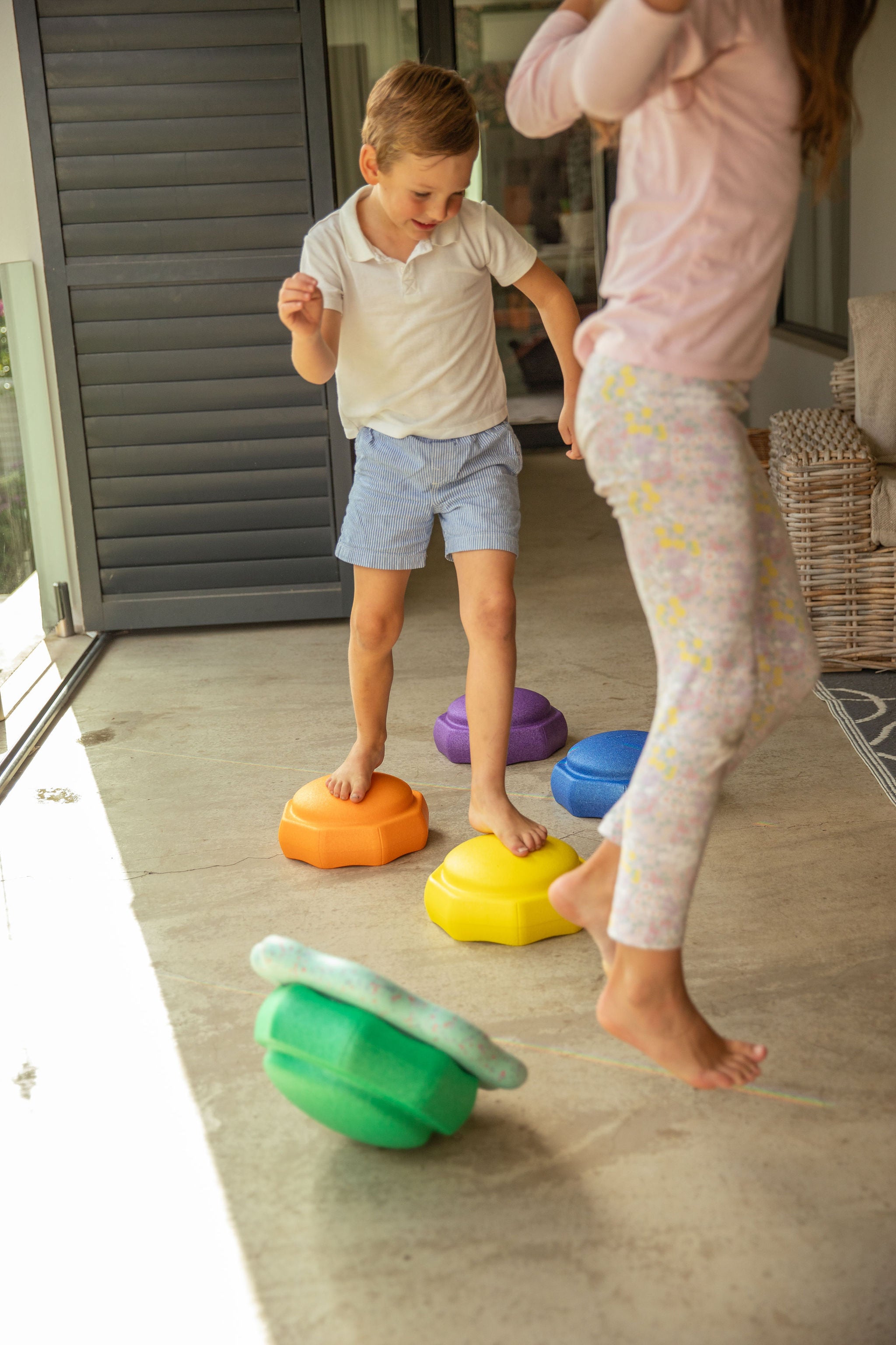 Colourful stepping stones laid out as an obstacle course for preschool gross motor and imaginative play