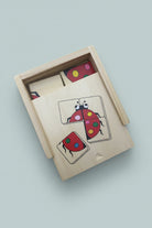 Wooden puzzle with ladybug design on a wooden surface