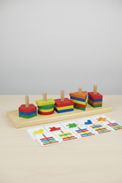 Colorful wooden geometric shapes on a wooden board with copy cards below