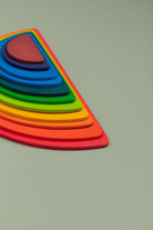Close-up of smooth non-toxic painted wooden rainbow stacker pieces showing texture and colour detail