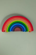 Rainbow stacker arches stacked in size order showing graduated sequence — Montessori size sorting toy