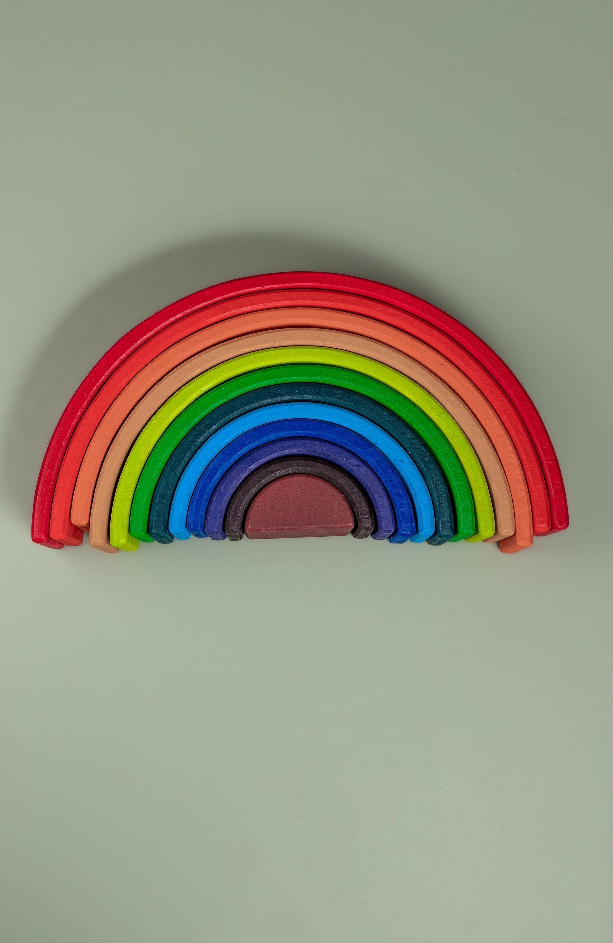 Rainbow stacker arches stacked in size order showing graduated sequence — Montessori size sorting toy