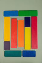 Wooden strip pieces from the building set laid out as a road or fence in imaginative play